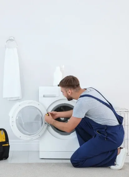 Technician repairing a washing machine